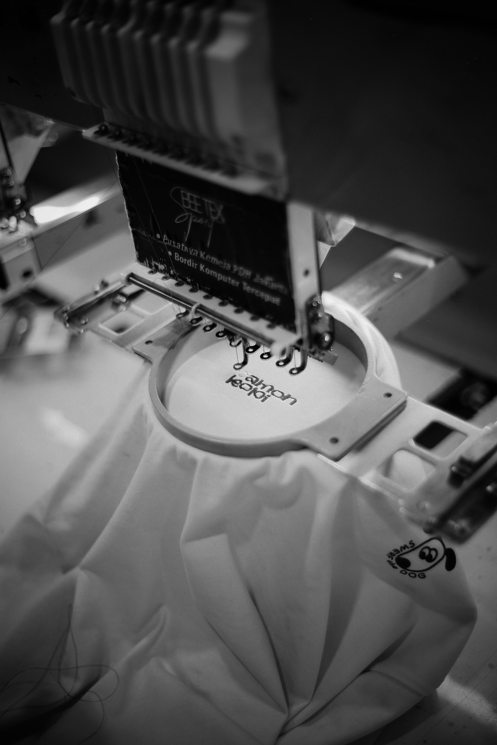 Embroidery machine stitching a logo onto a garment