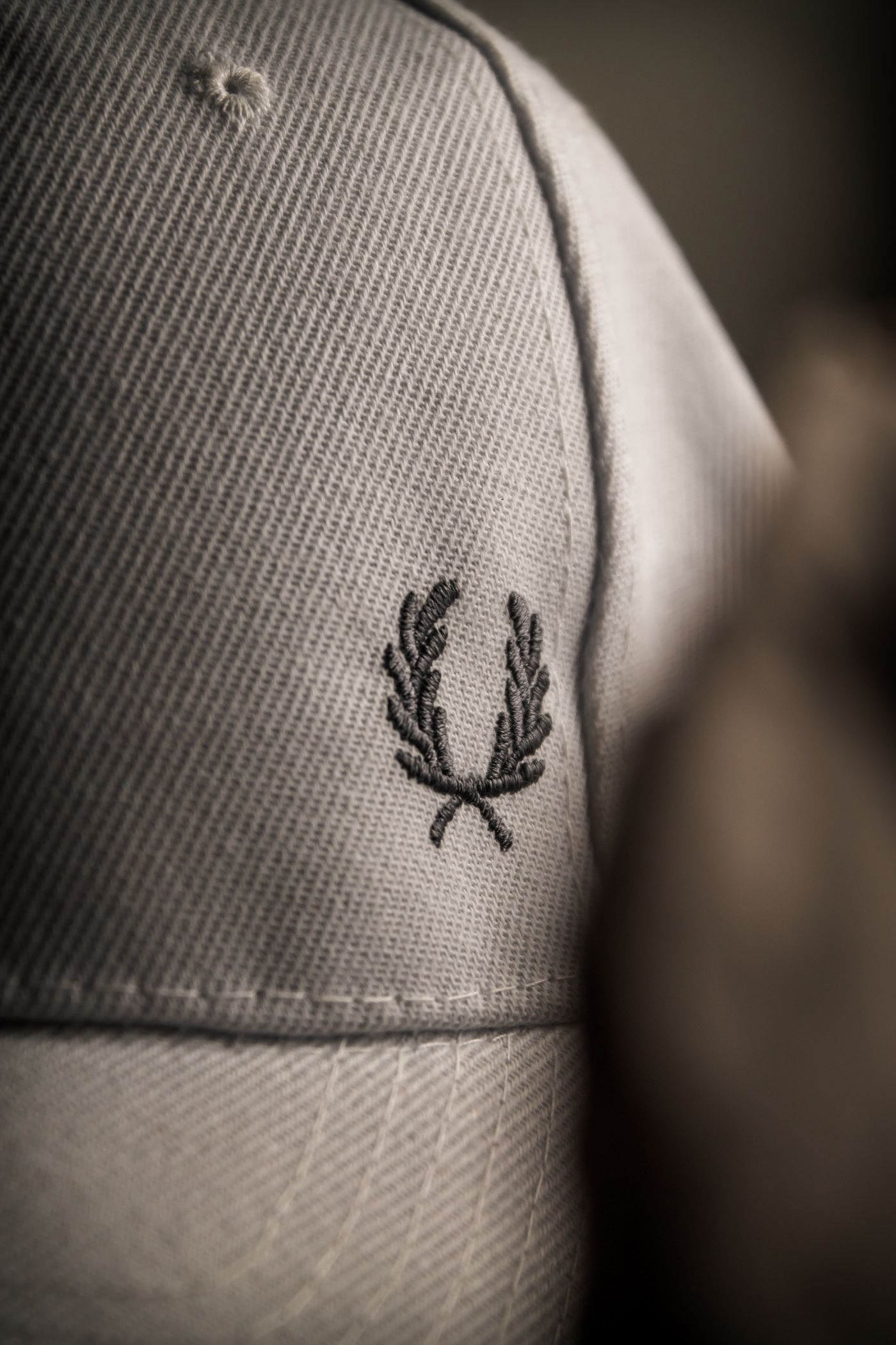 Close-up of raised embroidery stitches on a gray cap