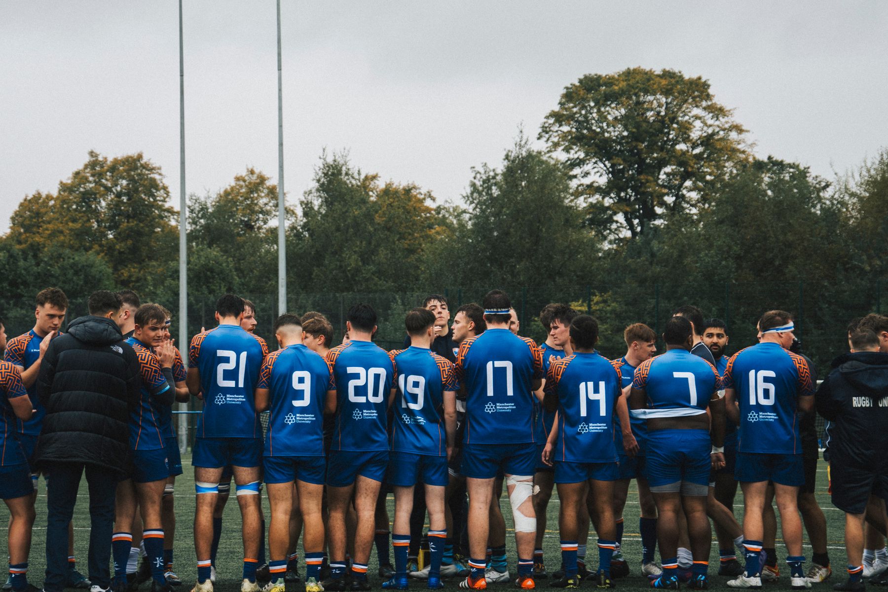 Team in personalized blue sports jerseys gathered together