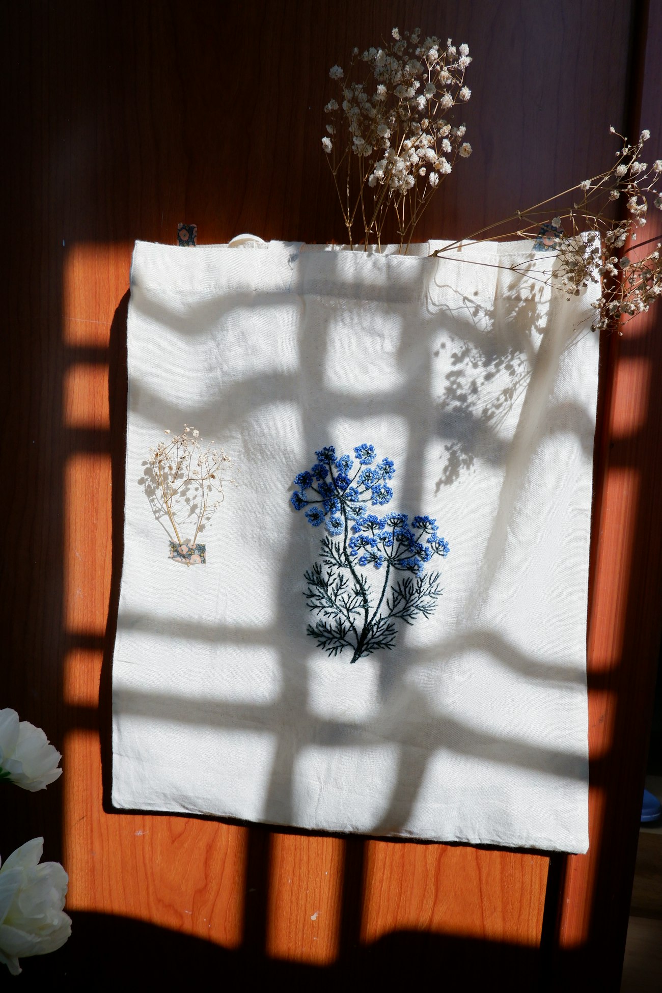 Canvas tote bag with detailed blue floral embroidery