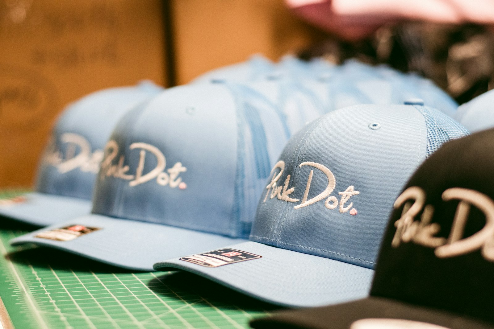 A row of caps with embroidered front panels