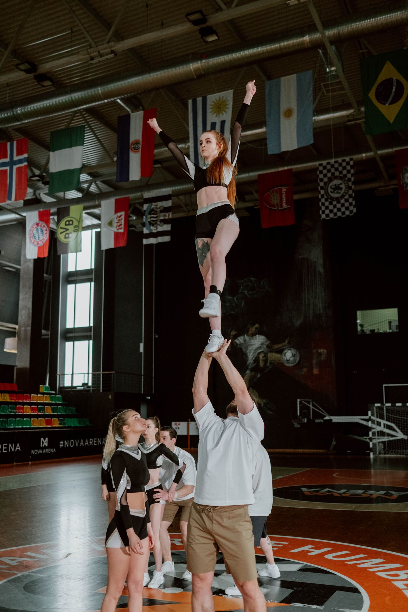 Performance team in coordinated uniforms during an indoor routine